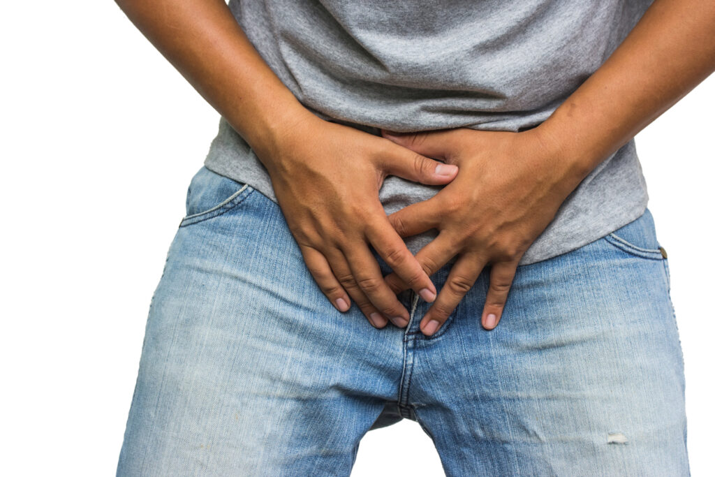 Man holding crotch, suffering from chlamydia
